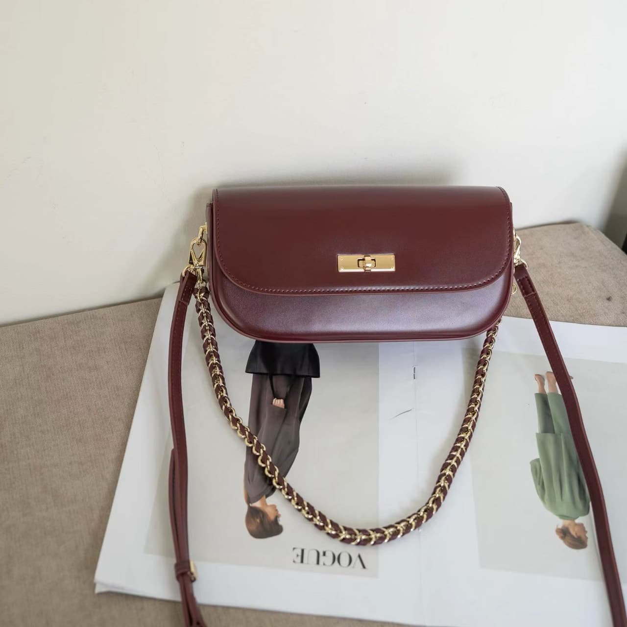 Owner-supplied photograph of a burgundy shoulder bag, shown as a construction reference